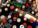 many bottles of alcohol sitting in a cooler on the floor