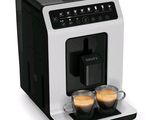 an image of a coffee machine with two cups of coffee in front of it