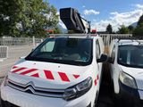 two white vans parked next to each other in a parking lot