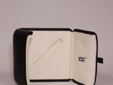 black and white case with a pen inside of it on a white surface