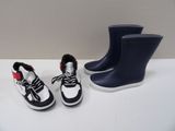 two pairs of shoes that are next to each other on a table