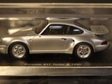 a silver model of a porsche 911 turbo car in a display case