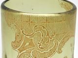a close up of a glass with a gold design on it
