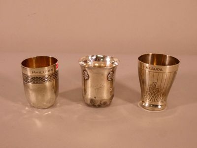 three silver cups sitting on top of a table next to each other