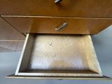 a wooden drawer with a metal handle in it