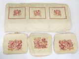 four pieces of cloth with flowers on them on a table