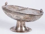 a silver bowl with a lid on a stand