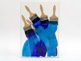 three blue paint brushes on top of a clear card
