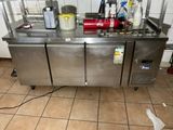 a stainless steel counter with a bunch of cleaning supplies on it