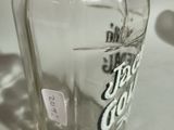 a glass bottle with a label on it sitting on a table