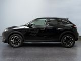 the black suv is parked on the concrete floor in the room