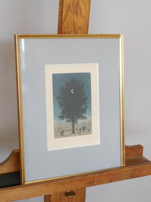 a picture of a tree in a picture frame on a easel
