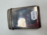a silver case with a tag on it on a table
