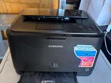 a black printer sitting on top of a washing machine