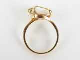 an image of a gold ring with a white stone in the middle
