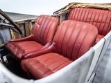 two red seats in the back of an old car