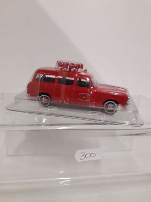 a red toy car on display in a clear box