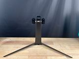 a close up of a camera on a tripod on a wooden table