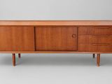 a mid century teak sideboard with three drawers and two doors