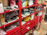 a red shelving filled with lots of items in a room