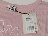 a pink t - shirt with a white design on it