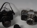three cameras sitting next to each other on a table