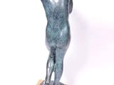 statue of a woman standing on a wooden base on a white background