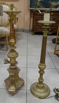 two candles that are sitting on the floor next to each other