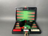 a black case with a green and red backgam set in it