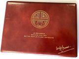 an image of a brown book with a gold emblem on it