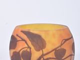 a vase that has a design of leaves on it