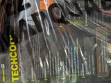 a lot of tennis racquets that are wrapped in plastic
