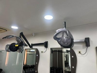 a photo of a hair salon with mirrors and lights