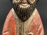 figurine of a man with a beard holding a bird in his hand