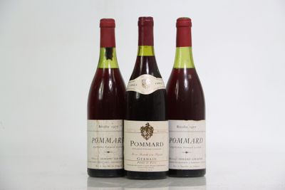 three bottles of wine are lined up on a table