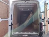a white van with a large piece of wood in the back of it
