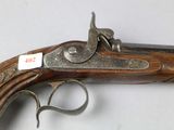 an old gun that is on display on a table