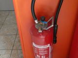 a fire extinguisor in the corner of a kitchen