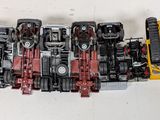 a lot of toy cars that are lined up on a table