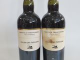 two bottles of wine sitting next to each other on a table