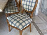 four chairs sitting next to each other in a room