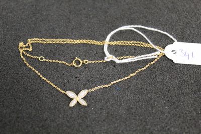 a close up of a necklace with a butterfly on it