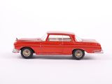 a red toy car sitting on a white surface