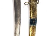 two different types of knives on a white surface