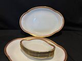 three plates with gold rims are stacked on top of each other
