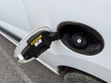 a close up of an electric car plugged into a charger