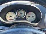 a close up of a car dashboard with gauges and a steering wheel