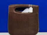 a brown purse with a white tag on it