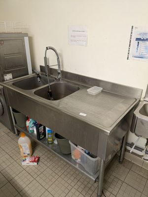 a sink and a washer in a small room