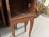 a small wooden table with a drawer on it